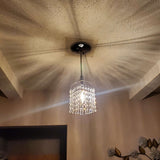 James R Moder Contemporary Austria Crystal Pendant light casting elegant shadows in a modern living space.